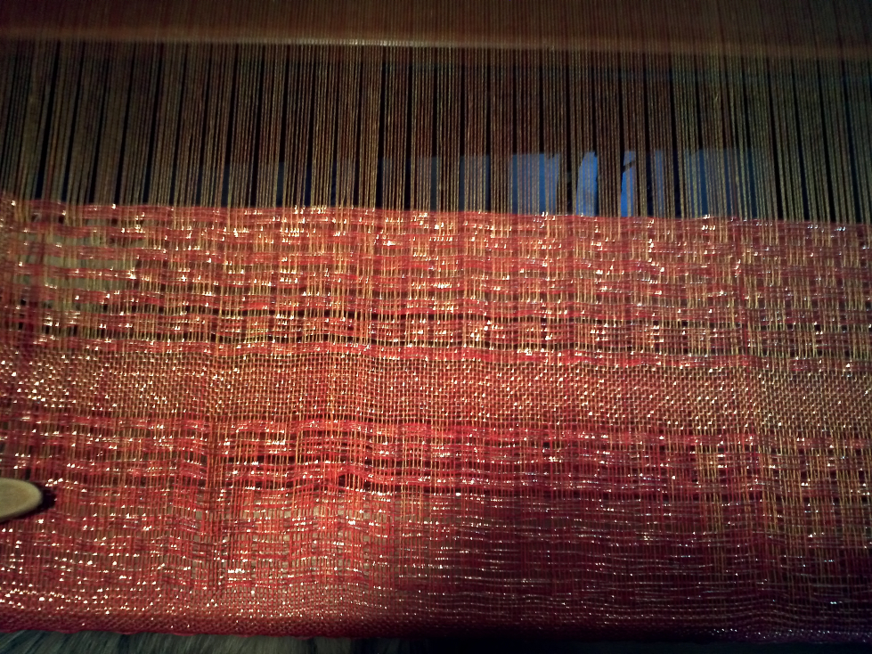 Shawl on loom with more weaving finished.